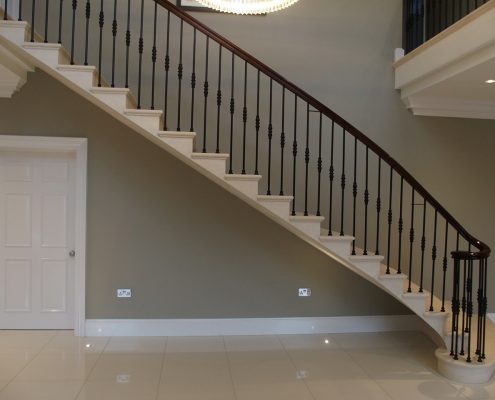handmade stone staircase attention to detail steel spindles sapele handrail fully moulded profile shape of the steel core rail manufacturing hand finishing tolerance of less than 1mm volute small bun stained French-polished traditional shellac