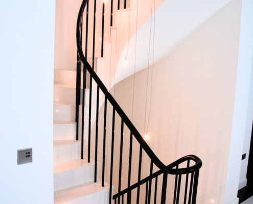 Sleek and modern staircase with sapele handrail and metal balusters