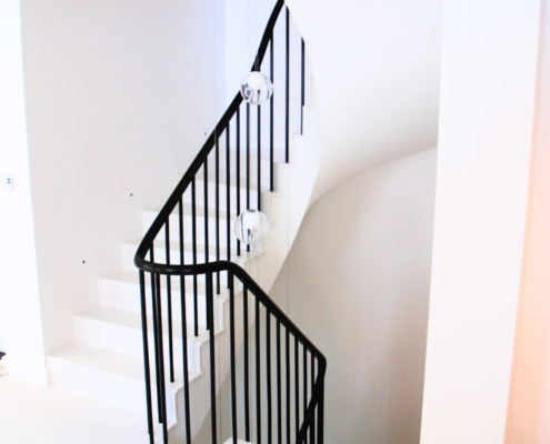 Contemporary staircase design with clean lines and polished sapele handrail