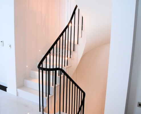 Sleek staircase Centrepiece of the home Sapele handrail Manufacture and polish Loose metal balusters Winder treads Clean and contemporary No core rail Home improvement Stylish design Custom installation Modern aesthetics Attention to detail Expert craftsmanship High-quality materials Polished finish Enhancing the interior Clean lines Contemporary staircase design Functional and elegant