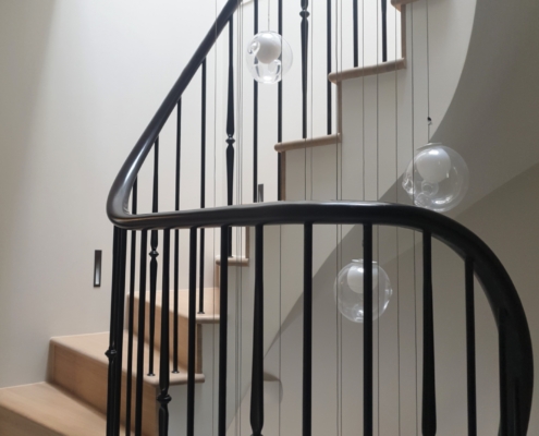 Bespoke balustrade Private residence Chelsea Sweeping timber handrails Interior designer Digital survey Fast installation Concrete staircases Mild steel spindles Precise holes drilled Handrail parts pre-assembled Leading supplier London Precision and attention to detail Experienced in-house fitters Curved sapele handrails CNC machines French polished in situ