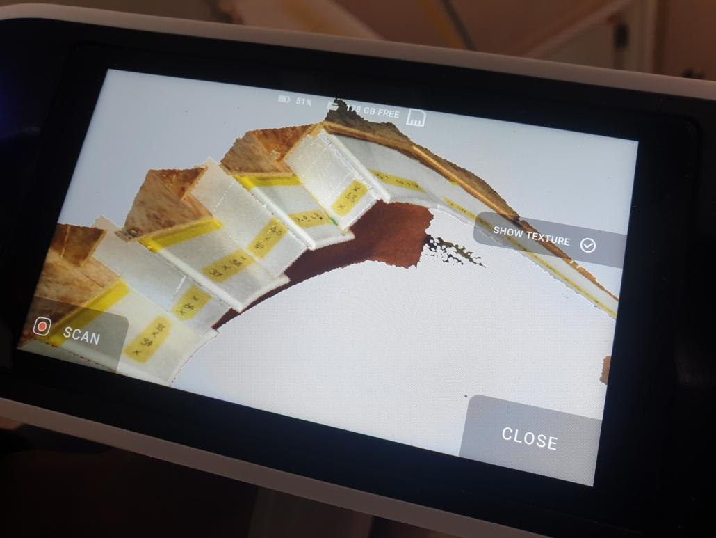 Tablet showing a 3D digital survey model of a curved staircase
