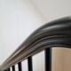 Bespoke curved handrail in Dark Black with matching coloured rounded spindles