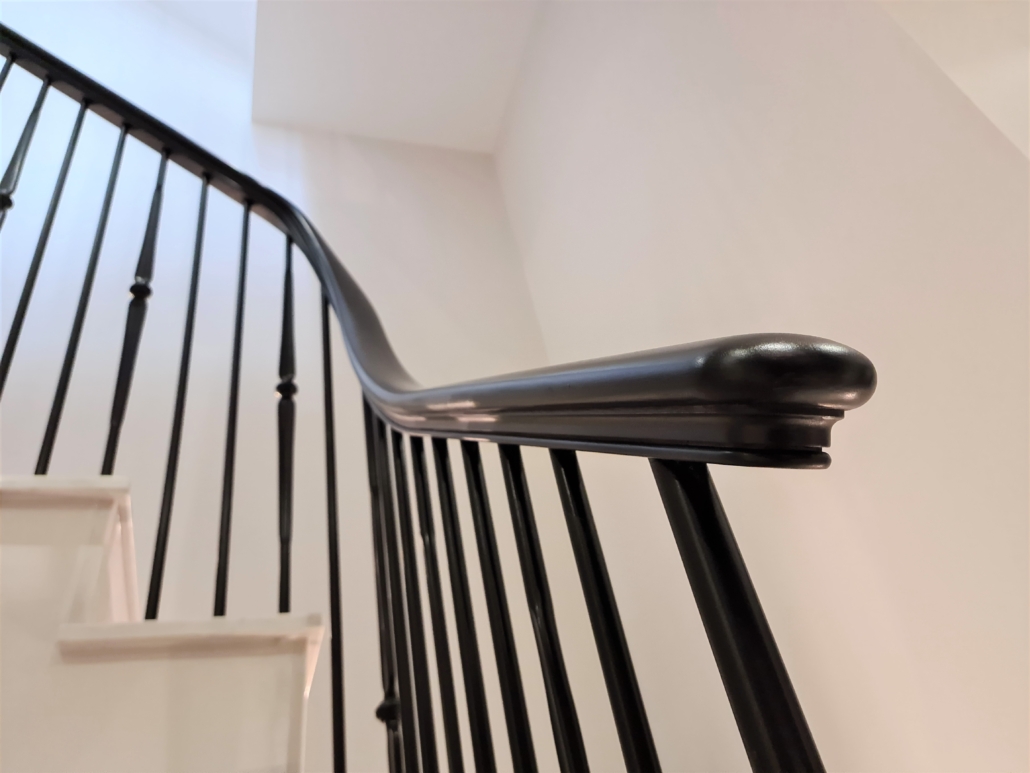 Handrail Creations, luxury house builder, Radlett, custom made staircase, continuous curved handrails, stone cladding, design team, bespoke balustrade, forged steel spindles, black painted, French polished, sapele handrail.
