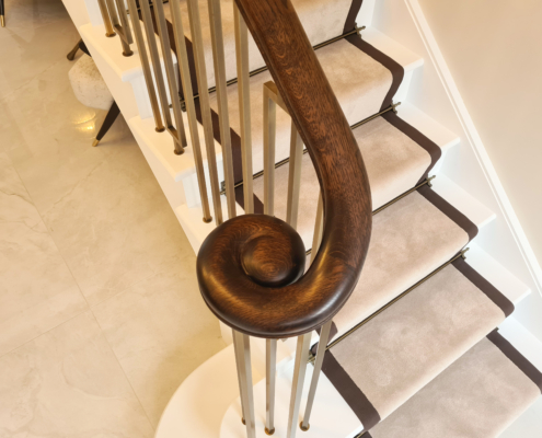 Brass Trend Private client Statement piece Digitally surveyed Geometric balustrade Continuous Oak handrails Stained to look like mahogany Fabricated Electro-plated Solid brass Brushed antique effect Wooden handrails Machined with square pockets Precision cut Spindles Installed Stained French polished Mahogany stain Director Kenny Macfarlane Popular Dark timber handrail In-house processes Client's ideas Bring to life