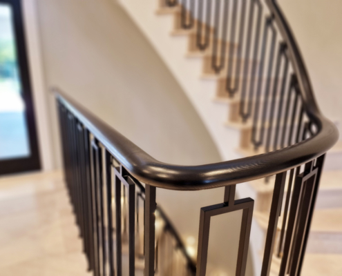 Faircross curved balustrade handrail staircases clad in stone balustrade spindle design Ash wooden handrail Curved balustrade and handrail St Albans staircases Private client project Instagram inspiration Curved concrete staircase Stone cladding Curved landings Closed-string softwood staircase Consistent design Art deco spindles Custom-made spindles Powder coated finish Ash handrails Off-black stain Exquisite home Building regulations compliance Elegant design Continuous wooden handrail Swan neck transitions Design challenges