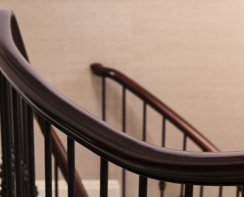 sapele handrails made to measure four sweeping flights Kensington home interior designers Albyns dark wood handrail feature staircase standard profile CNC manufacturing individual spindles steel core precision craftsman Manchester factory