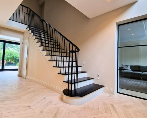 Impressive staircase design in Essex with steel balustrade.