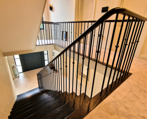 Focal point staircase with bespoke steel and wood design.
