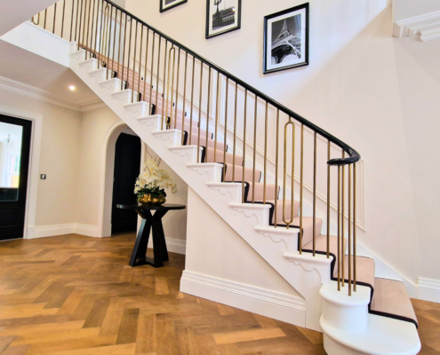 Unique brass 'hooped' balustrades and wooden handrails at 'Fairfields' in Surrey