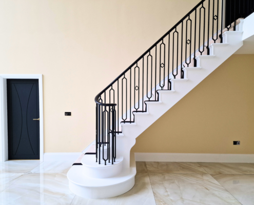 Contrast of black handrail and spindles against a white timber staircase, creating a visually captivating focal point.
