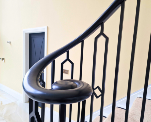 Continuous handrail with sleek square pocket design, seamlessly integrating with steel spindles.