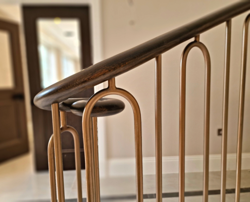 stunning curved balustrade double-stone-clad helical staircase bespoke steel shaped spindles bronze paint European Oak handrails 5 axis CNC machine French polished custom-made balustrade curved staircase North London