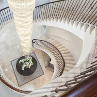 Hawk eye view of stone spiral staircase with Black Walnut helical handrails and steel balustrade