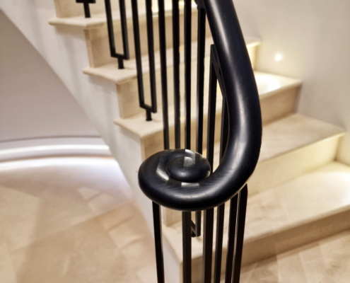 Faircross curved balustrade handrail staircases clad in stone balustrade spindle design Ash wooden handrail Curved balustrade and handrail St Albans staircases Private client project Instagram inspiration Curved concrete staircase Stone cladding Curved landings Closed-string softwood staircase Consistent design Art deco spindles Custom-made spindles Powder coated finish Ash handrails Off-black stain Exquisite home Building regulations compliance Elegant design Continuous wooden handrail Swan neck transitions Design challenges