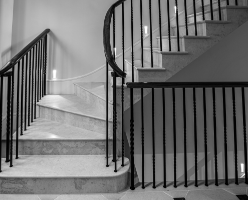 White staircase with Black wooden handrails and Black steel balustrade