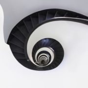 Spiral staircase in an old building with continuous sweeping handrail