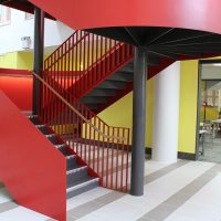 Red steel staircase with bespoke Oak handrails