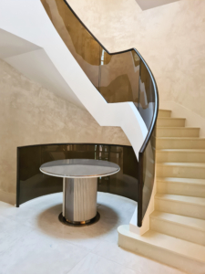 Handrail Creations, private client, sapele handrails, bronze-tinted glass balustrade, curved glass panels, 3D scan, perfect length, pre-joint, factory, installation, French polisher, London, ebony doors, attention to detail.
