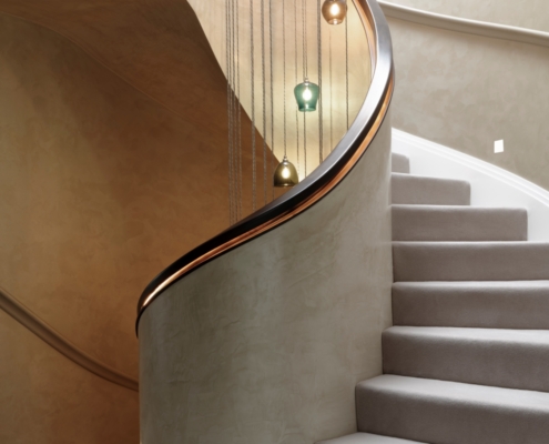 Handrail Creations Handrail design Architects Fisher id Contractor Manak Homes In-house team Engineers Designers Geometric style rail Continuous LED strips Striking final product Black walnut helical handrails Polished plastered solid balustrade High-end residential project London Stand-out feature Multi-million pound home Engineer their vision Surveyed Undulations Helical 'pigs ear' handrail White contrast