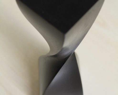 CNC machined timber trophy in Black with twsit