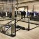Timber profile Gloss Black handrail straight and helical sections on glass balustrade in retail store.