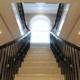 Black handrails either side of stone staircase with matching coloured balustrade