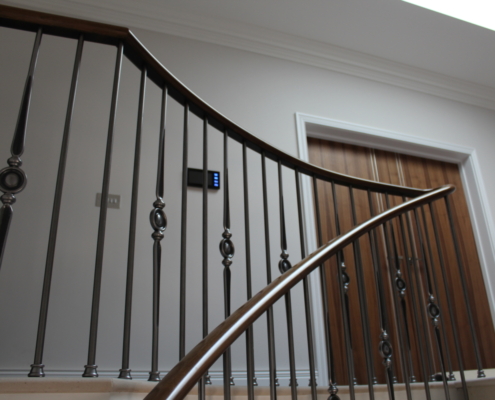 French polish Stone clad stair Surrey Design team Stonemasons Steel spindles Black walnut handrails Core rail Steep pitch Precision drilling 16.5mm holes Perfect fit Handrail finish Lightfast stain French polished