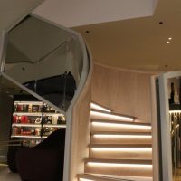 Curved staircase with oak handrails and cladding