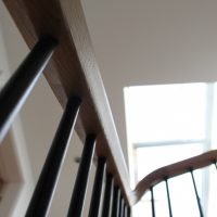 Hardwood handrail in London townhouse, plain Black spindles
