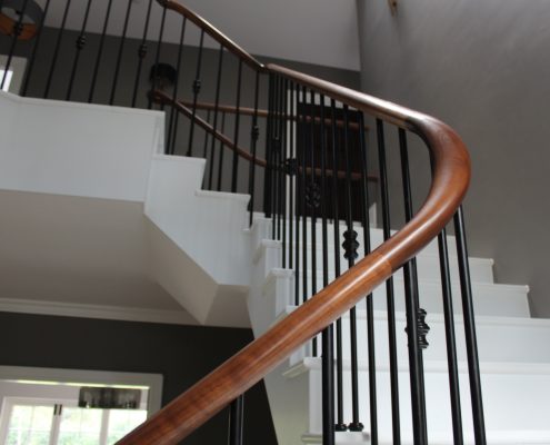 Stone staircase with Walnut handrail wreathing section