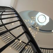 Handrail Creations elliptical staircase American ash handrails forged steel spindles balustrade design fast installation system seamless process John Swift Homes Cheshire contemporary interior design