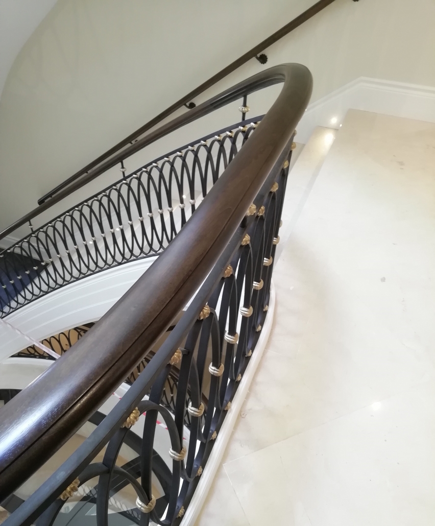 Handrail supply and install Black walnut handrails Residential project North of London Master blacksmith Matt Livsey Hammond Steel core rail Classic mould Frogs back detail Bespoke handrails CNC manufactured Curved and helical rail French polished Balustrade Fitting team
