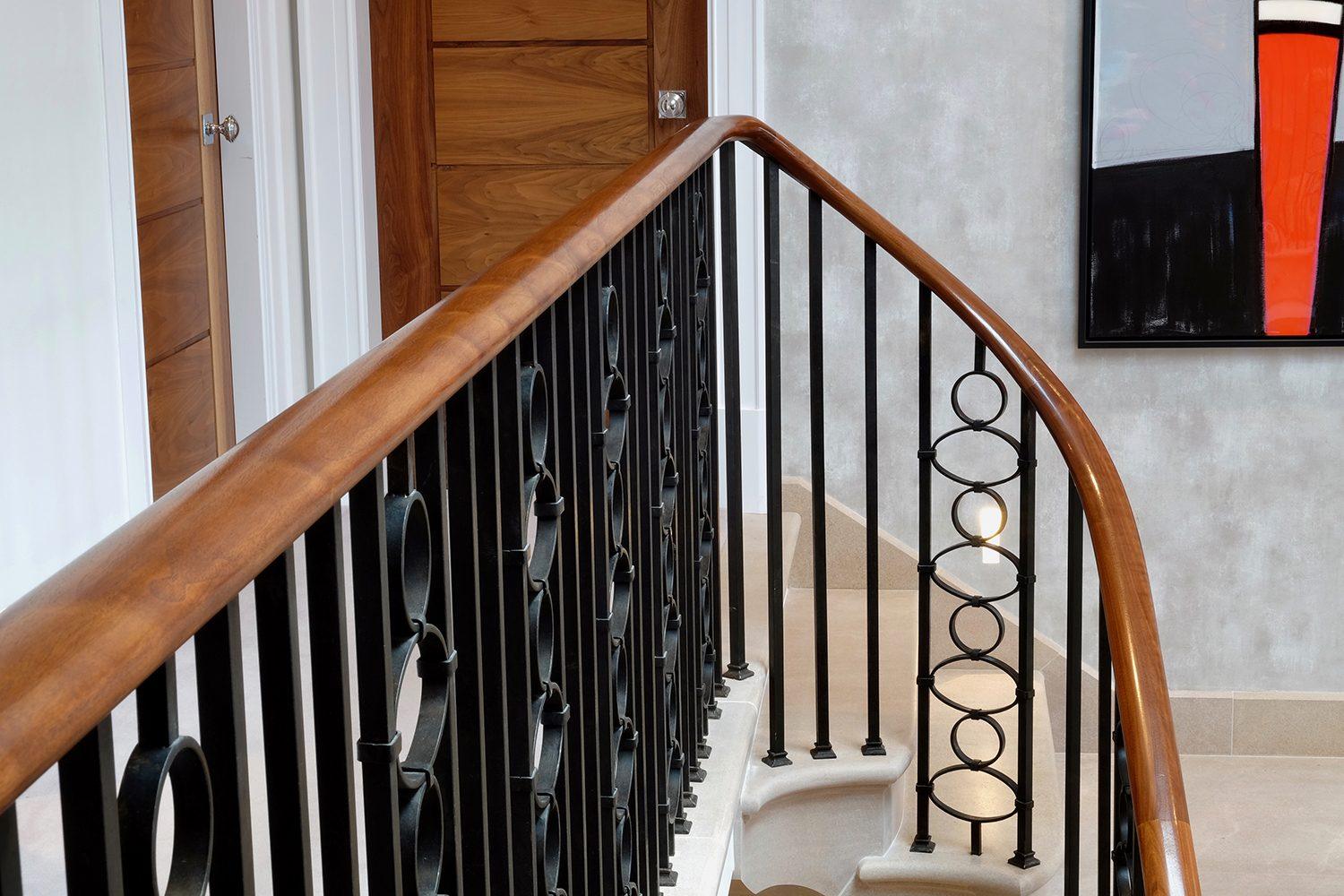 Landing handrail in Sapele with steel black balustrade