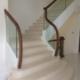 American Black walnut handrail, sweeping into drop end newel posts, glass balustrade