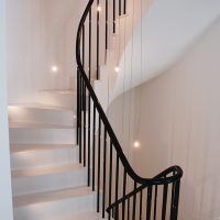 Continuous rising Black timber handrail with Black steel rounded spindles