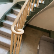 Oak volute (monkey tail) with curved handrail and wooden rounded spindles