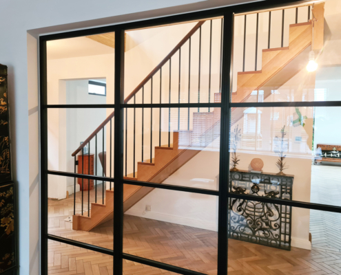 Ruislip hallway timber staircase handrail and balustrade sapele handrails French polish stain Staircase through crittall windows.