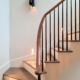 Steel Black tapered round spindles, LED wall light every couple of treads