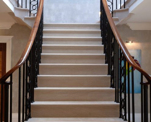 UK's leading stonemasons Artisan blacksmiths Magnificent centrepiece staircase Project in Sutton Coldfield Birmingham Black walnut handrails French-polished Matching surrounding furniture Customer satisfaction Sweeping staircases Expert team