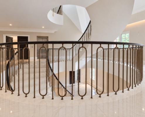First floor gallery balustrade with bronze hoop spindles and continuous oak handrail