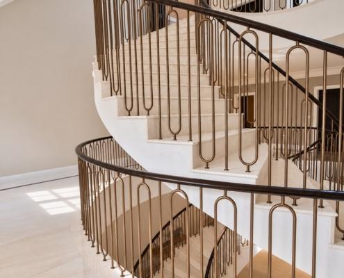 Side view of the helical staircase showing bronze hoop spindles and curved oak handrail