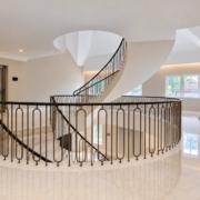Landing balustrade with bronze hoop spindles looking across to the helical staircase