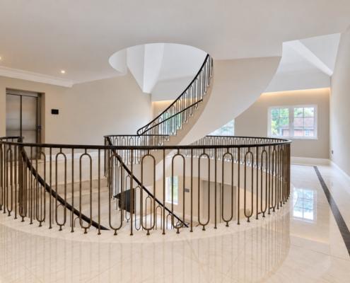 Landing balustrade with bronze hoop spindles looking across to the helical staircase