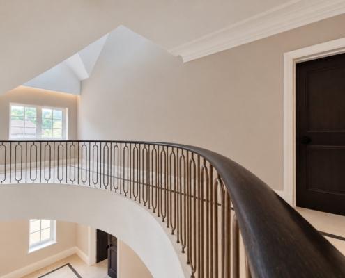 French polished oak handrail sweeping along the first floor landing