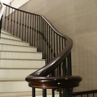 Walnut monkey tail with rising handrail and steel spindles