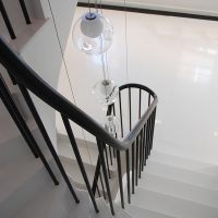 Continuous rising Black timber handrail with Black steel rounded spindles