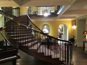 Curved staircase with helical handrail & steel rounded spindles